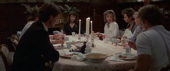 Movie still from “April Fool's Day” (1986), directed by Fred Walton – A group of people sitting around a dinner table; Wide shot, High angle