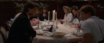 Movie still from “April Fool's Day” (1986), directed by Fred Walton – A group of people sitting around a dinner table; Wide shot, High angle