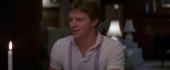 Movie still from “April Fool's Day” (1986), directed by Fred Walton – A man in a white shirt is sitting down; Close Up shot, Low angle