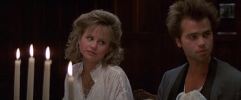 Movie still from “April Fool's Day” (1986), directed by Fred Walton – A woman sitting in front of a lit candle in a room; Close Up shot, Over the shoulder angle