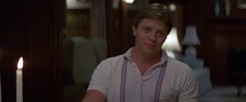 Movie still from “April Fool's Day” (1986), directed by Fred Walton – A young man wearing a white shirt and a striped tie; Close Up shot, Over the shoulder angle