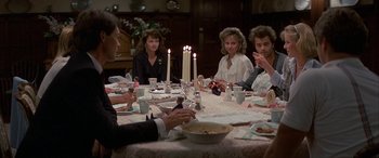 Movie still from “April Fool's Day” (1986), directed by Fred Walton – A group of people sitting around a dinner table; Medium shot, High angle
