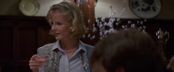 Movie still from “April Fool's Day” (1986), directed by Fred Walton – A woman in a blue shirt is looking at the camera; Close Up shot, Over the shoulder angle