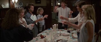 Movie still from “April Fool's Day” (1986), directed by Fred Walton – A group of people standing around a dinner table; Medium shot, High angle