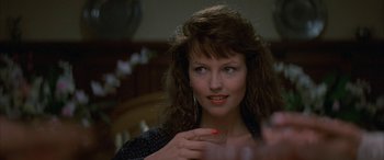 Movie still from “April Fool's Day” (1986), directed by Fred Walton – A person wearing a black shirt; Close Up shot, Over the shoulder angle