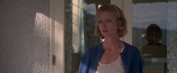 Movie still from “April Fool's Day” (1986), directed by Fred Walton – A woman in a white shirt and a blue sweater; Close Up shot, Low angle