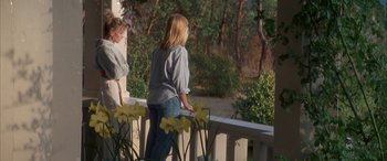 Movie still from “April Fool's Day” (1986), directed by Fred Walton – Two young girls standing on a deck looking out at the woods; Medium shot, High angle