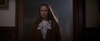 Movie still from “April Fool's Day” (1986), directed by Fred Walton – A woman with long brown hair wearing a brown jacket; Medium shot, Low angle