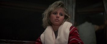Movie still from “April Fool's Day” (1986), directed by Fred Walton – A woman with a towel wrapped around her neck; Close Up shot, Over the shoulder angle