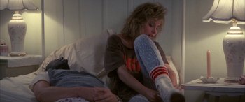 Movie still from “April Fool's Day” (1986), directed by Fred Walton – A woman sitting on a bed next to another woman; Medium shot, Over the shoulder angle