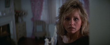 Movie still from “April Fool's Day” (1986), directed by Fred Walton – A person wearing a black shirt; Close Up shot, Over the shoulder angle