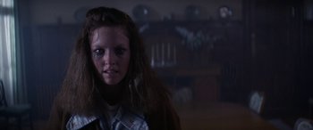 Movie still from “April Fool's Day” (1986), directed by Fred Walton – A young girl with long dark hair stares into the camera; Close Up shot, Low angle