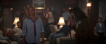 Movie still from “April Fool's Day” (1986), directed by Fred Walton – A group of people in a living room; Medium shot, Low angle