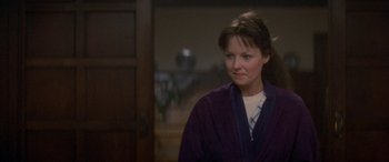 Movie still from “April Fool's Day” (1986), directed by Fred Walton – A woman in a purple robe looking to her left; Close Up shot, Over the shoulder angle