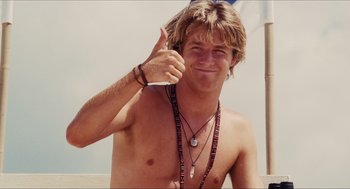Movie still from “Aquamarine” (2006), directed by Elizabeth Allen Rosenbaum – A young man giving a peace sign while holding a cell phone; Close Up shot, Low angle