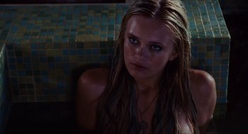 Movie still from “Aquamarine” (2006), directed by Elizabeth Allen Rosenbaum – A beautiful young lady sitting in front of a tile wall; Close Up shot, High angle