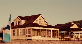Movie still from “Aquamarine” (2006), directed by Elizabeth Allen Rosenbaum – An old house with a porch sitting in the middle of a field; Extreme Wide shot, Low angle