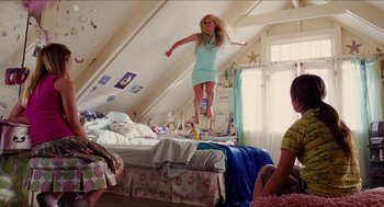 Movie still from “Aquamarine” (2006), directed by Elizabeth Allen Rosenbaum – A girl jumping on a bed in a room; Wide shot, Low angle
