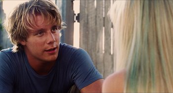 Movie still from “Aquamarine” (2006), directed by Elizabeth Allen Rosenbaum – A man sitting next to a woman on a couch; Close Up shot, Over the shoulder angle