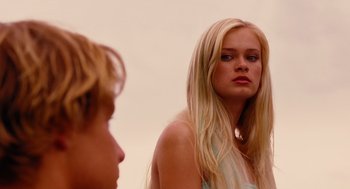 Movie still from “Aquamarine” (2006), directed by Elizabeth Allen Rosenbaum – A young blonde woman standing in front of a young boy; Close Up shot, Over the shoulder angle