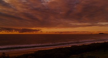 Movie still from “Aquamarine” (2006), directed by Elizabeth Allen Rosenbaum – A view of the ocean at sunset from the beach; Extreme Wide shot, High angle