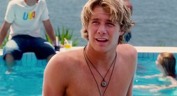 Movie still from “Aquamarine” (2006), directed by Elizabeth Allen Rosenbaum – A young man with blond hair wearing a necklace; Close Up shot, Over the shoulder angle