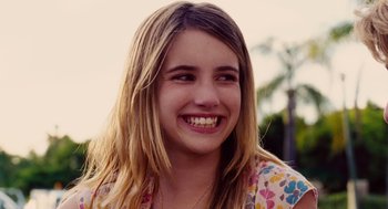 Movie still from “Aquamarine” (2006), directed by Elizabeth Allen Rosenbaum – A young woman with long blonde hair smiling for the camera; Close Up shot, Over the shoulder angle