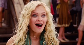 Movie still from “Aquamarine” (2006), directed by Elizabeth Allen Rosenbaum – A woman with blonde curly hair and a surprised look on her face; Close Up shot, Low angle
