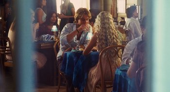 Movie still from “Aquamarine” (2006), directed by Elizabeth Allen Rosenbaum – A man and a woman are sitting at a table; Medium shot, Over the shoulder angle