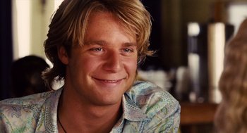 Movie still from “Aquamarine” (2006), directed by Elizabeth Allen Rosenbaum – A person wearing a shirt smiling; Close Up shot, Over the shoulder angle