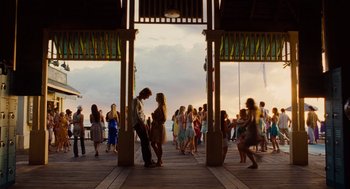 Movie still from “Aquamarine” (2006), directed by Elizabeth Allen Rosenbaum – A group of people standing on top of a wooden deck; Extreme Wide shot, Over the shoulder angle