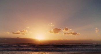 Movie still from “Aquamarine” (2006), directed by Elizabeth Allen Rosenbaum – The sun is setting over the ocean with the sky in the background; Extreme Wide shot, Low angle