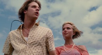 Movie still from “Aquamarine” (2006), directed by Elizabeth Allen Rosenbaum – A man and a woman standing next to each other in front of a cloudy sky; Medium shot, Low angle