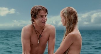Movie still from “Aquamarine” (2006), directed by Elizabeth Allen Rosenbaum – A man and a woman standing next to a body of water; Medium shot, Over the shoulder angle