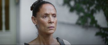 An older woman is looking into the distance