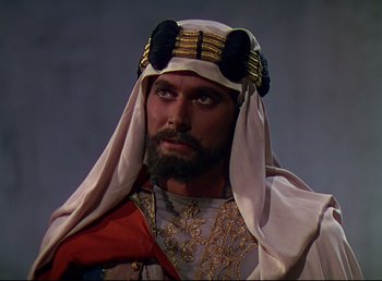 Movie still from “Arabian Nights” (1942), directed by John Rawlins – A man with a beard wearing a turban; Close Up shot, High angle