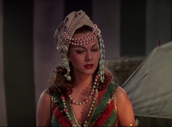 Movie still from “Arabian Nights” (1942), directed by John Rawlins – A woman with a head piece and a necklace; Close Up shot, Over the shoulder angle