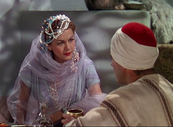 Movie still from “Arabian Nights” (1942), directed by John Rawlins – A man and a woman are talking to each other; Medium shot, Over the shoulder angle
