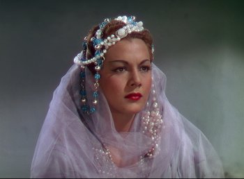 Movie still from “Arabian Nights” (1942), directed by John Rawlins – A woman wearing a tiara and a veil; Close Up shot, Low angle