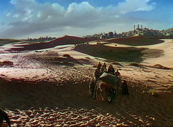 Movie still from “Arabian Nights” (1942), directed by John Rawlins – A group of people riding on the back of a horse; Extreme Wide shot, High angle