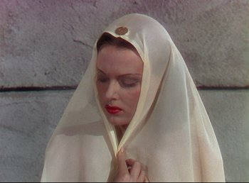 Movie still from “Arabian Nights” (1942), directed by John Rawlins – A woman with a white veil covering her face; Close Up shot, Low angle