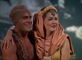Movie still from “Arabian Nights” (1942), directed by John Rawlins – A man and a woman are posing for a picture; Medium shot, Low angle
