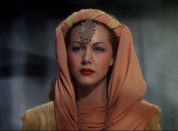 Movie still from “Arabian Nights” (1942), directed by John Rawlins – A woman with a headpiece on her head; Close Up shot, Low angle