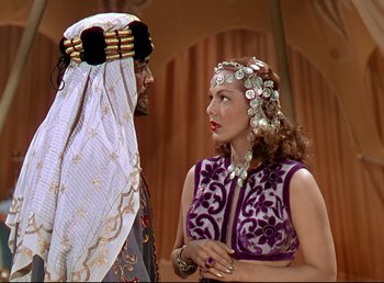 Movie still from “Arabian Nights” (1942), directed by John Rawlins – A man and a woman talking to each other; Medium shot, Over the shoulder angle