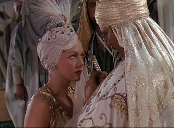 Movie still from “Arabian Nights” (1942), directed by John Rawlins – A woman in a turban and a man in a white turban; Medium shot, Over the shoulder angle