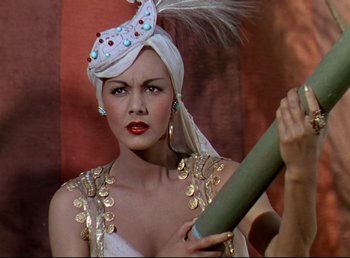 Movie still from “Arabian Nights” (1942), directed by John Rawlins – A woman in a white turban holding an object; Close Up shot, Low angle
