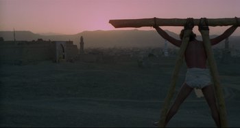 Movie still from “Arabian Nights” (1974), directed by Pier Paolo Pasolini – A view of a city at sunset from a distance; Wide shot, Low angle
