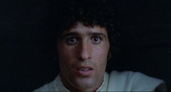 Movie still from “Arabian Nights” (1974), directed by Pier Paolo Pasolini – A person with curly black hair; Close Up shot, Low angle