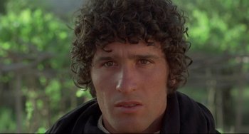 Movie still from “Arabian Nights” (1974), directed by Pier Paolo Pasolini – A person wearing a jacket; Close Up shot, Over the shoulder angle