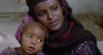 Movie still from “Arabian Nights” (1974), directed by Pier Paolo Pasolini – A woman and a child are posing for a picture; Close Up shot, Over the shoulder angle